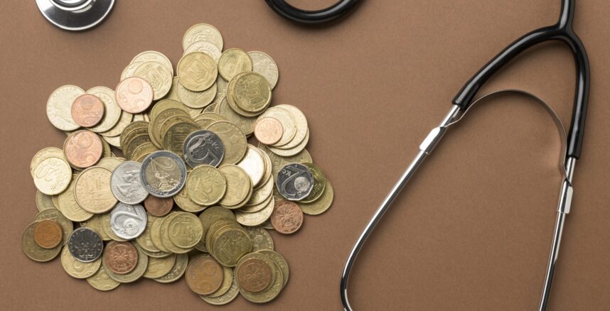 bunch-coins-arrangement-with-stethoscope bunch coins arrangement with stethoscope scaled