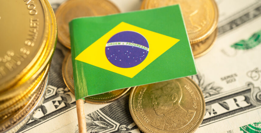 Stack of coins money with Brazil flag, finance banking concept. pedro braggio moro nos eua o tarifaco pode me atrapalhar scaled